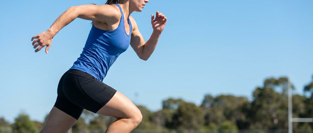 A runner sprinting with arms pumping