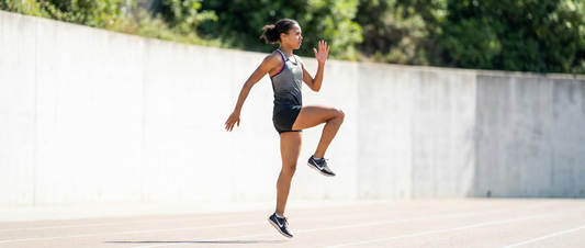 An athlete performing a high knees drill